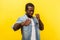 Ready for fight. Portrait of aggressive man standing with clenched fists. indoor studio shot isolated on yellow