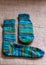 Ready-made knitted sock from green striped yarn, handicrafts as a hobby, knitting concept
