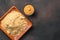 Ready-made mustard and mustard powder on a brown concrete background