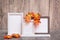 Ready Mock up. Three empty photo frames on a stand and orange maple leaves stand on a table. White-orange-beige color scheme