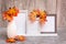 Ready Mock up. Three empty photo frames on a stand and a vase with orange maple leaves stand on the table