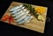 Ready to cook Fresh Fish Horse / Indian Mackerel Fish Decorated with herbs and Vegetables on a wooden pad