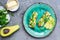 Ready-to-eat bruschettas with salmon, butter, avocado and arugula on a plate