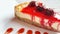 Ready to eat raspberry cheesecake on a white plate