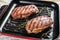 Ready to eat steak Top Blade beef breeds, black Angus meat. Gray background. Top view