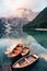 Ready to explore. Wooden boats on the crystal lake with majestic mountain behind. Reflection in the water