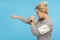 Ready to fight! Side view of feisty woman with short curly hair in sweatshirt punching to side with aggressive expression