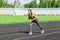 Ready to go. Close up photo of female athlete on high start starting line. Girl on Stadium track, preparing for a run. Sports and