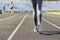 Ready to go. Close up photo of shoe of female athlete on the starting line. Girl on Stadium track, preparing for a run. Sports and