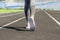 Ready to go. Close up photo of shoe of female athlete on the starting line. Girl on Stadium track, preparing for a run. Sports and