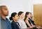 Ready to impress. Shot of a group of businesspeople seated in line while waiting to be interviewed.