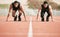 Ready to start. Full length shot of two handsome young male athletes starting their race on a track.