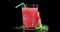 Ready watermelon smoothie in glass with tube slowly rotates.