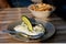 Real authentic photo of fresh Greek Tzatziki yogurt dip and pita bread and pickels in restaurant under golden hour