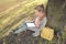 Real businesswoman with tablet laptop at work outdoors in park