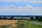 Real countryside paved road along the wheat field