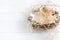 Real empty bird nest on white wooden background, copy space