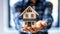 A real estate agent delicately holds a small model house in his hands, symbolizing dreams of home ownership, mortgage