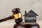 Real estate concept auction gavel and little house with inscription Home