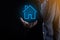 Real estate concept, businessman holding a house icon.House on Hand.Property insurance and security concept. Protecting gesture of