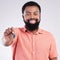 Real estate, happy and portrait of a black man with keys isolated on a white background in a studio. Smile, pride and