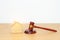 Real Estate Law, Home Insurance, property Tax, Auction and Bidding concepts. small toy house model with gavel justice hammer on