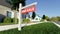 Real estate sign in front of a house for sale in a nice suburban neighborhood. Digital 3D render