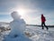 Real icy snowman in winter landscape