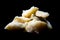 Real Italian Parmiggiano Reggiano Parmesan cheese on a black background with cutting light