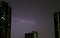 The Real Lightning Flashing on Night Sky over the High Buildings