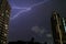 The Real Lightning Flashing in Night Sky over High Buildings of Bangkok