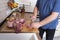 Real men cutting fresh raw meat on board in white kitchen. Preparing pork meat, cooking