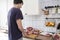 Real men cutting fresh raw meat on board in white kitchen. Preparing pork meat, cooking