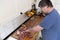 Real men cutting fresh raw meat on board in white kitchen. Preparing pork meat, cooking