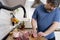 Real men cutting fresh raw meat on board in white kitchen. Preparing pork meat, cooking