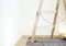 Real old wooden ladder of a painter in use for an interior renovation. Painter cover fleece for protection of floor surfaces.