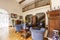 Real photo of an elegant living room interior with blue sofa and armchairs, wooden stairs, guard rail and table