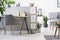 Real photo of grey chair standing by the wooden desk with books