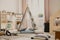 Real photo of a scandi playroom interior with a tent and pillows. Boy putting a toy on a shelf