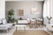 Real photo of a spacious dining and living room interior with wooden furniture and plants on a pedestal