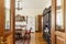 Real photo of a spacious, wooden dining room interior with a set