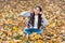 Real relaxation. autumn kid fashion. inspiration. happy childhood. back to school. girl among maple leaves in park. fall