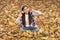 Real relaxation. autumn kid fashion. inspiration. happy childhood. back to school. girl among maple leaves in park. fall