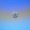 Real snowflake glittering on smooth gradient background