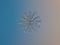 Real snowflake glittering on smooth gradient background