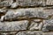Real stone wall of ancient stones of gray-beige color