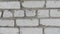 Real texture in the form of a wall of white brick, smooth movement of the camera