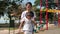 Real time Asian Chinese mother helping daughter with playground obstacles