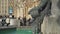 Real time medium shot of the Figure of a boy on the famous fish fountain on the Marienplatz in Munich, Germany.