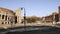 Real time shot of traffic nearby the Colosseo in Rome. The Colosseum also known as the Flavian Amphitheatre, an oval